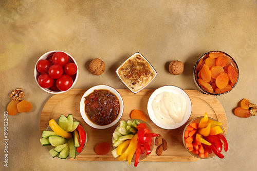 Cuadro en lienzo Middle East plate, Healthy food cuisine background with hummus bowl and raw vegetable sticks, nuts and dried apricots