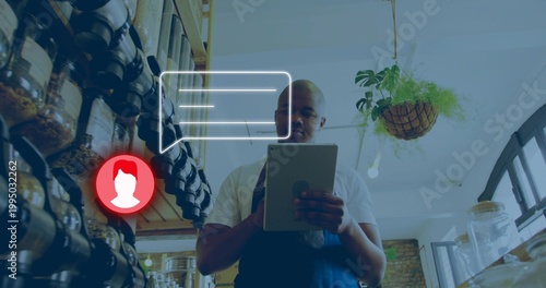 Holding shop owner wearing dark apron checking tablet in retail shop, with labeled jars, UI overlay