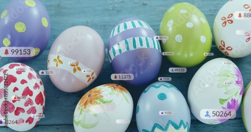 Displaying cluster of decorated eggs sitting on blue painted plank surface, with overlay tags