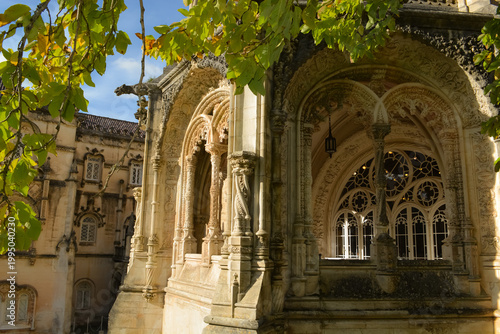 Blooming bougainvillea and vegetation in the park in front of the Busaco Palace in Portugal Coimbra region. Themes include travel, cultural heritage, and natural beauty.