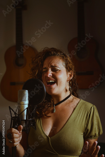 Woman singing and recording vocals in home studio