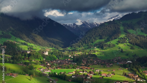 Quadro su tela Grindelwald village with swiss alps and sunlight breaking through clouds