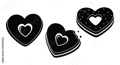 Three black heart shaped cookies with bite marks a striking silhouette
