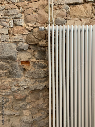 Rustic interior wall with heating radiator. Minimal home environment