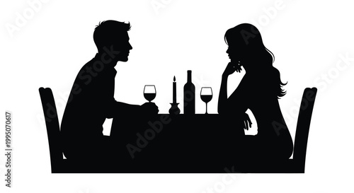 Silhouette of a couple enjoying a romantic dinner at a table