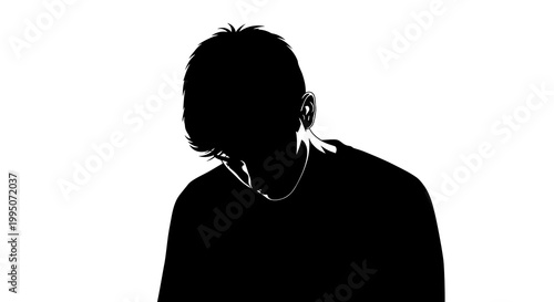 Silhouette of a young man with his head lowered in contemplation