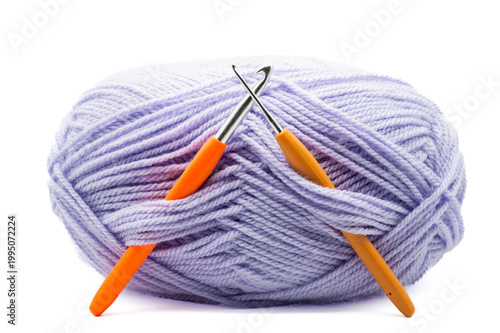 A ball of knitting and two knitting needles on a white background