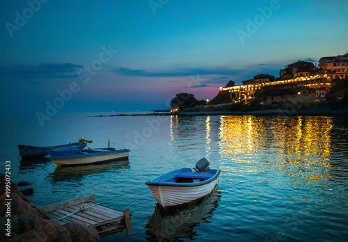 фотографія A boat parked by the shore at sunset in Nessebar, an old town on the Black Sea coast in Bulgaria