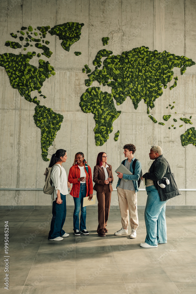 Fototapeta premium Diverse students talking about global education and environmental sustainability in university hallway with biophilic world map