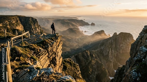 A solitary figure stands at the jagged cliff edge overlooking a vast coastal valley, misty ocean horizon stretching infinitely below, dramatic rock formations casting