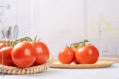 Tomatoes, beautiful red tomatoes in rustic bowls on a very bright kitchen counter, selective focus.