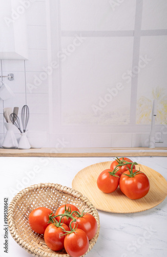Tomatoes, beautiful red tomatoes in rustic bowls on a very bright kitchen counter, selective focus.