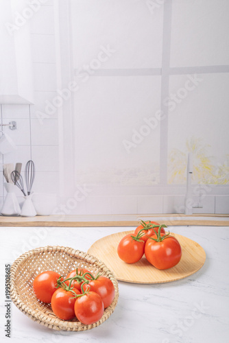 Tomatoes, beautiful red tomatoes in rustic bowls on a very bright kitchen counter, selective focus.