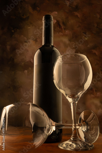 Bottle and wine glass, bottle and wine glass on a rustic wooden surface and abstract background, low key photo, selective focus.