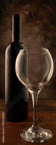 Bottle and wine glass, bottle and wine glass on a rustic wooden surface and abstract background, low key photo, selective focus.