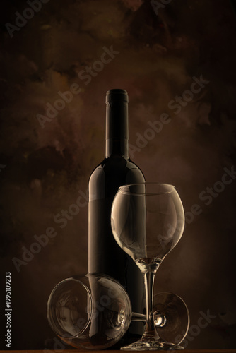 Bottle and wine glass, bottle and wine glass on a rustic wooden surface and abstract background, low key photo, selective focus.
