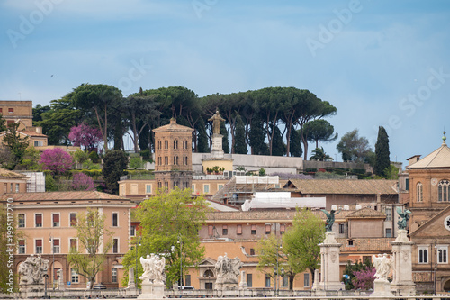 Photography View on stone-arched bridge on Tiber river in Rome, balustrade, marble statues,