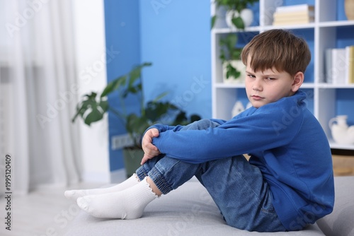 Fotografie Portrait of resentful little boy at home