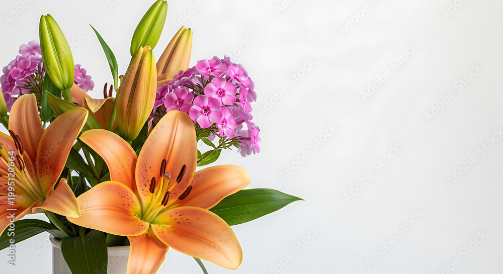 Obraz premium Orange lilies and pink phlox in vase on neutral background 