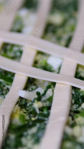 Decorating homemade pie with dough strips baking preparation closeup pastry oven tray