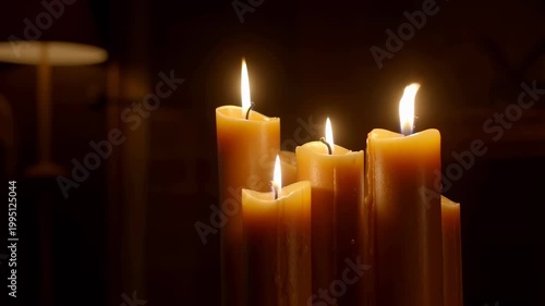 Flickering candles casting a warm glow in a dimly lit room. Ideal for creating a cozy and inviting atmosphere for relaxation or celebration