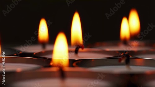 Flickering tea light candles in a dark setting, creating a warm and inviting atmosphere for relaxation and meditation. Perfect for enhancing ambiance and tranquility