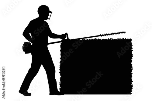 Silhouette of a worker carefully trimming a hedge with a power tool.