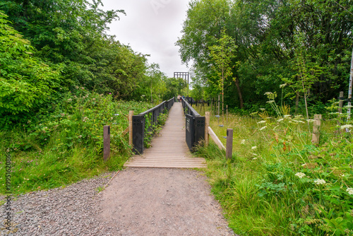 The Tur Viewing Platform at Cuningar Loop, Scotland, UK, is a landmark viewing platform and lookout tower providing elevated, treetop views across the woodland park, the River Clyde, the Hope statue. 