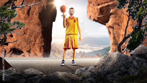 Basketball. A basketball player practices on a basketball court in the wilderness. A beautiful landscape is in the background.