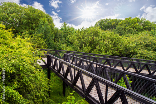The Tur Viewing Platform at Cuningar Loop, Scotland, UK, is a landmark viewing platform and lookout tower providing elevated, treetop views across the woodland park, the River Clyde, the Hope statue. 