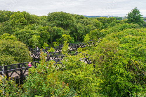 The Tur Viewing Platform at Cuningar Loop, Scotland, UK, is a landmark viewing platform and lookout tower providing elevated, treetop views across the woodland park, the River Clyde, the Hope statue. 