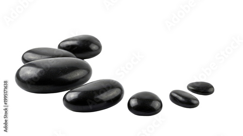 Polished black spa stones arranged on white background