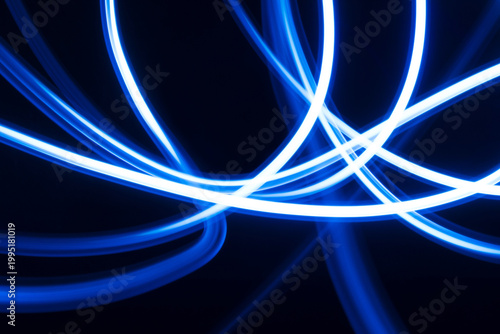 Dynamic Blue Light Trails Swirling Abstract Design Showcasing Vibrant Energy and Futuristic Visual Effects