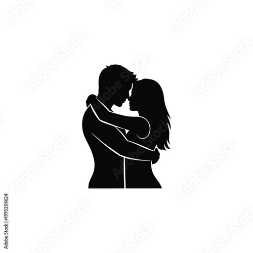 Silhouette of couple embracing closely.