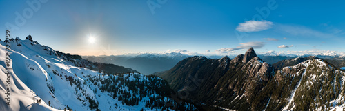 Sunlit Snowy Mountain Panorama Over Rugged Peaks in British Columbia, Canada at Sunset