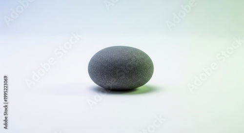Smooth grey natural river stone on a minimalist background capturing a sense of calm and organic
