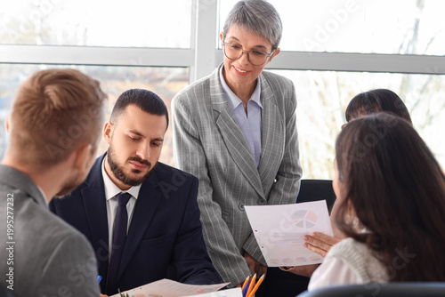 Female business consultant working with people in office