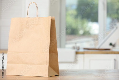 Paper shopping bag on woode...