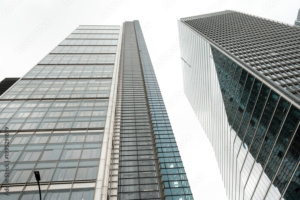 Fototapeta premium Modern glass skyscrapers reaching high into the urban sky