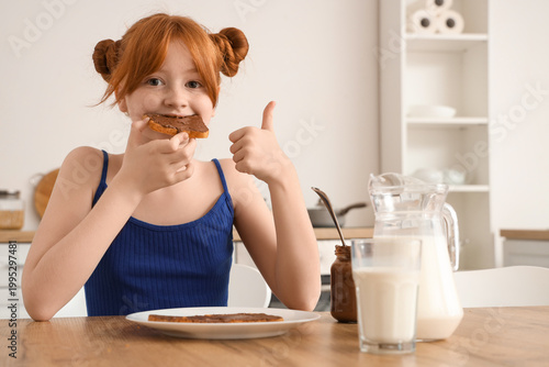 Cute girl eating toast with...