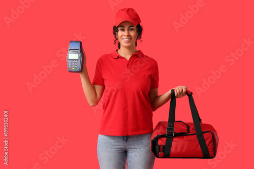 Female African-American courier holding thermal bag and payment terminal on r...