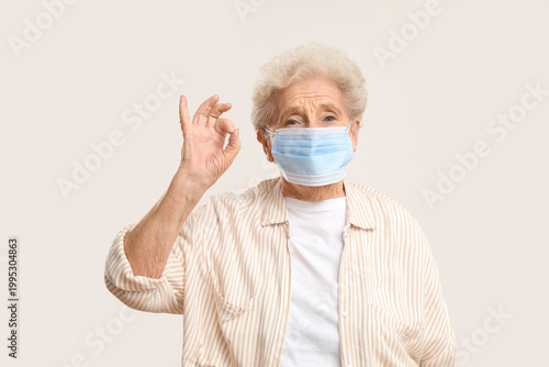 Elderly woman in medical ma...