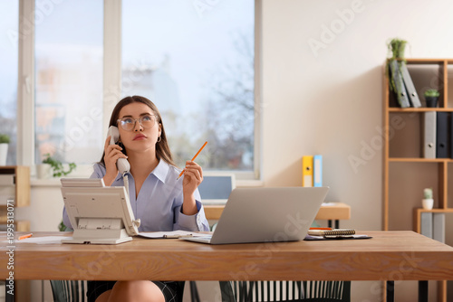 Thoughtful young secretary ...