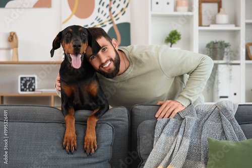 Young man with Dobermann do...