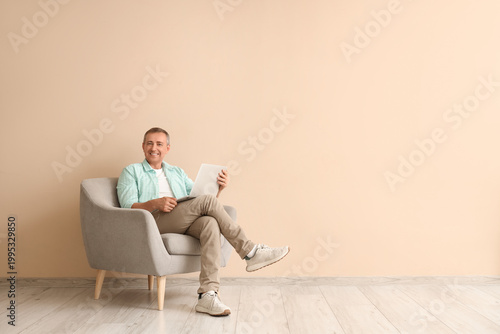 Old man with laptop sitting...