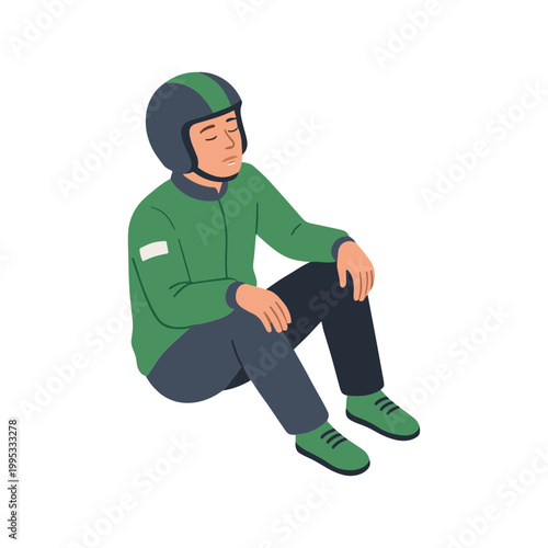 A person wearing a green helmet sits on the floor exhausted