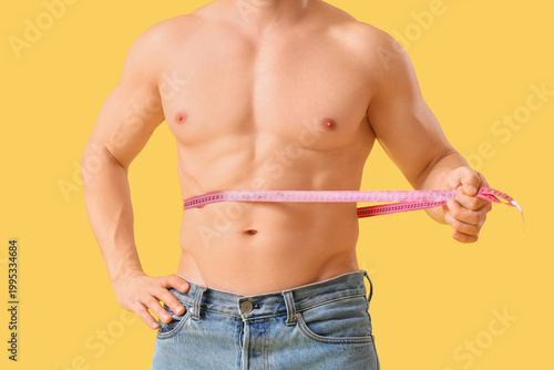 Male bodybuilder measuring ...