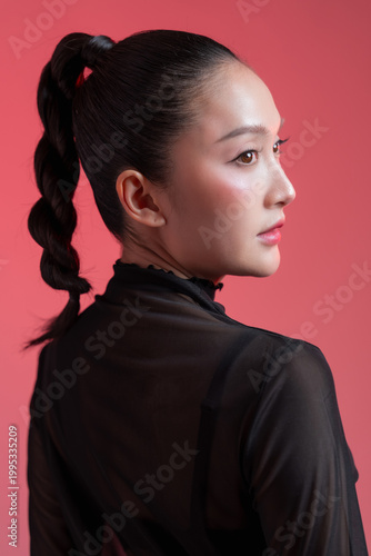 Canvas Print stunning young East Asian woman showing her side profile, featuring a sleek high braided ponytail and flawless glowing makeup