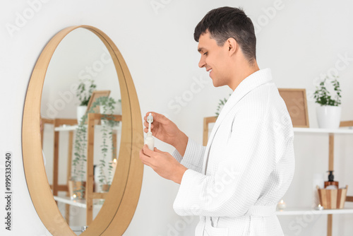 Young man with serum near m...