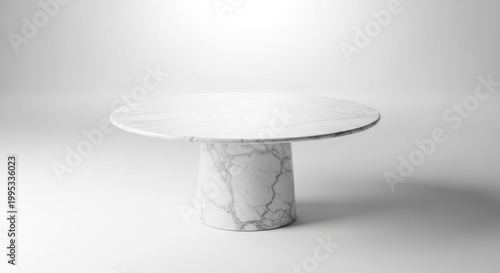 A white marble table with a round top and cylindrical base featuring gray veining